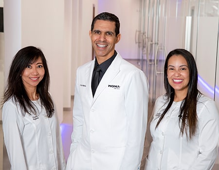 Dr. Melendez with two of his assistants at the Nona Smiles dental office