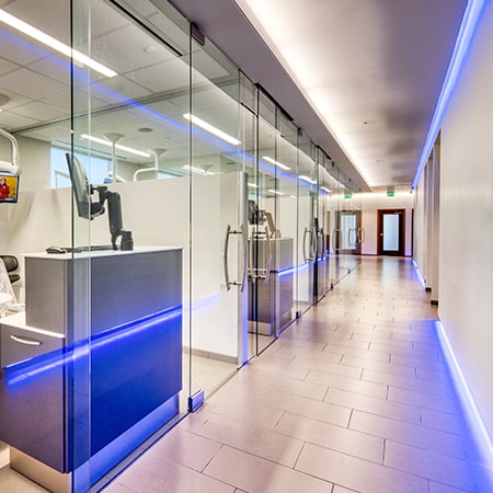 The corridor of the dental office of Nona Smiles showing some neon lights