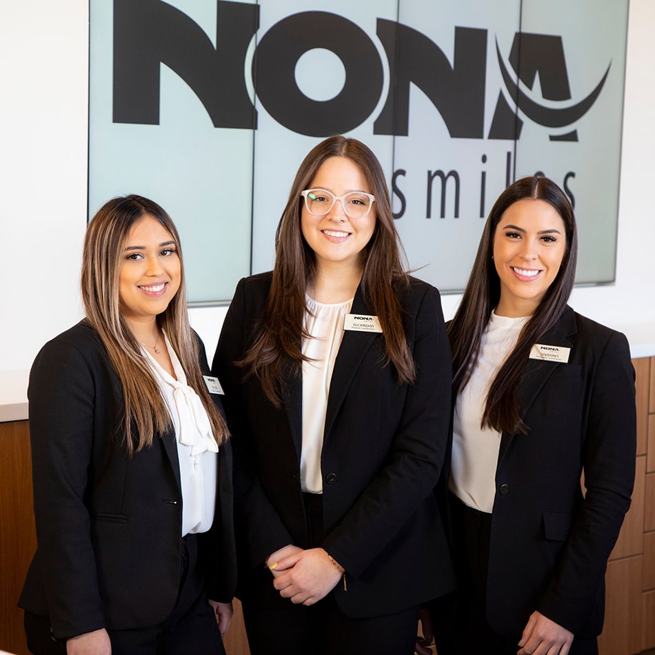 Three of the Nona Smiles team members smiling